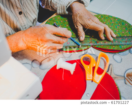 Senior woman hand design with Sewing equipment laptop and smartphone on white background Senior woman hand design with Sewing equipment laptop and smartphone on white background 61701227