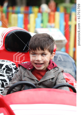 Happy Little boy in park attraction. Concept joy Happy Little boy in park attraction. Concept joy 61701709