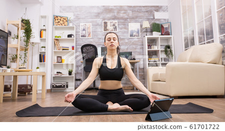 Young beautiful woman with eyes closed in zen mood 61701722
