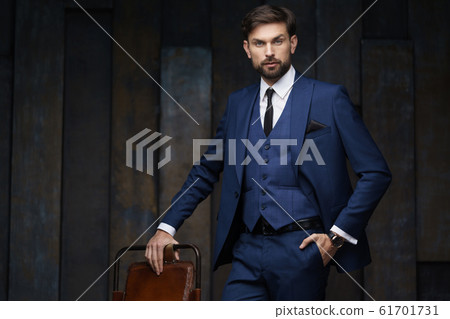 indoor photo of young handsome stylish businessman wearing suit indoor photo of young handsome stylish businessman wearing suit 61701731