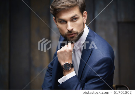 indoor photo of young handsome stylish businessman wearing suit indoor photo of young handsome stylish businessman wearing suit 61701802