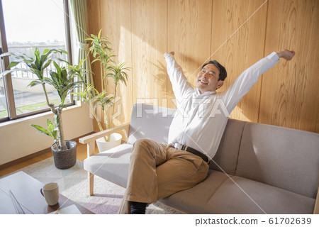 Middle-aged senior man relaxing in the living room Middle-aged senior man relaxing in the living room 61702639