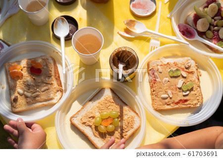 Edible sandwich made of white wheat bread, jam, bananas and marmalade 61703691