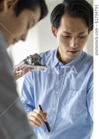 A first-class architect of a design office examining a layout while checking the Building Standards Law at home renovation A first-class architect of a design office examining a layout while checking the Building Standards Law at home renovation 61704791