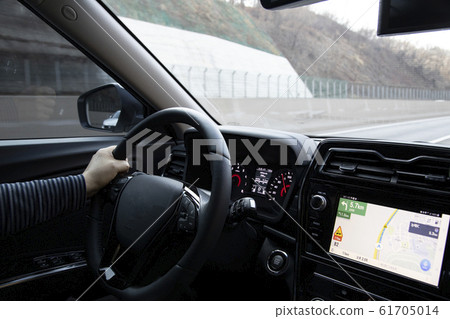 A person driving with the navigation turned on 61705014