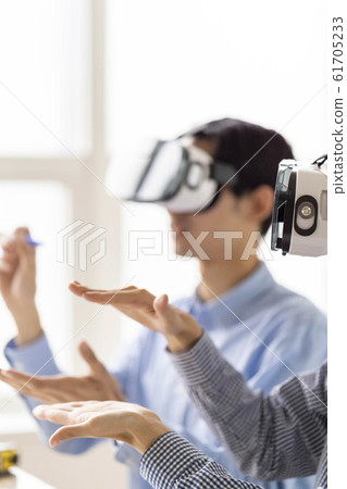 Lifestyle of two men who experience the latest technology of 5G in 3D with VR goggles 61705233