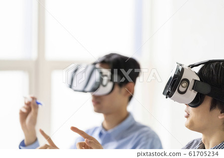 Lifestyle of two men who experience the latest technology of 5G in 3D with VR goggles 61705234