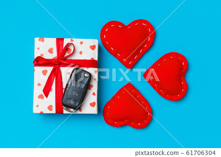 Top view of car key on gift box and red textile Top view of car key on gift box and red textile 61706304