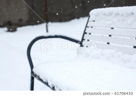 Benches for rest are covered with snow in the park Benches for rest are covered with snow in the park 61706430
