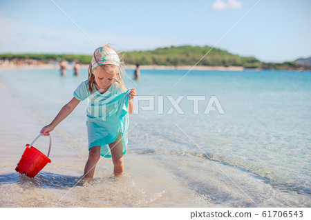 Cute little girl at beach during summer vacation Cute little girl at beach during summer vacation 61706543