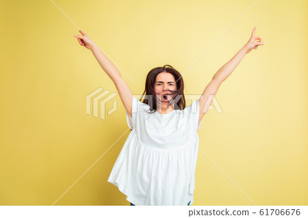 Easter bunny woman with bright emotions on yellow studio background Easter bunny woman with bright emotions on yellow studio background 61706676