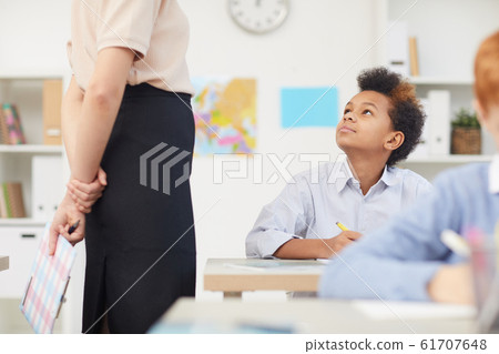 African boy talking to teacher African boy talking to teacher 61707648