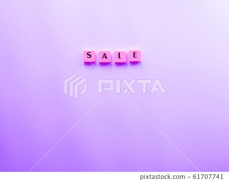 Sale word composed with plastic tiles on purple 61707741