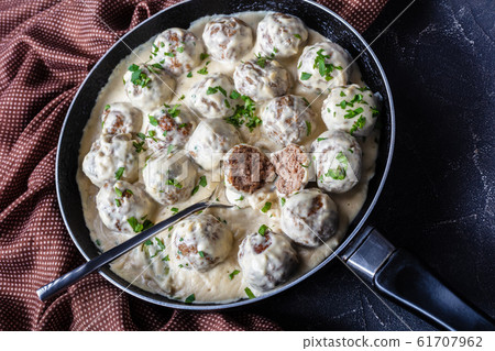 classic Swedish meatballs in a pan with spoon classic Swedish meatballs in a pan with spoon 61707962