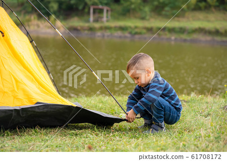 Little boy in a tent. Camping in the nature. 61708172