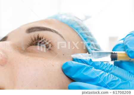 Close-up, beautician makes beauty injections into 61708209