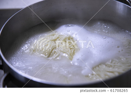 Noodles cooking in a pot 61708265
