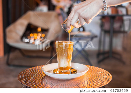 Iced coffee with milk in tall glasses. Iced coffee with milk in tall glasses. 61708469