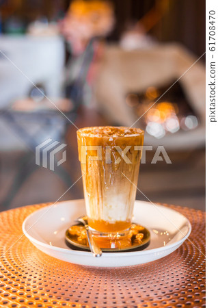 Iced coffee with milk in tall glasses. Iced coffee with milk in tall glasses. 61708470
