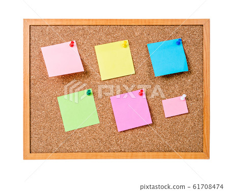 Blank sticky notes pinned on cork memo board. 61708474