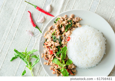 Rice topped with stir-fried pork and basil in 61708481