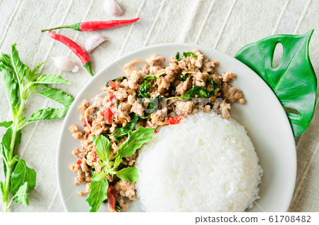 Rice topped with stir-fried pork and basil in 61708482