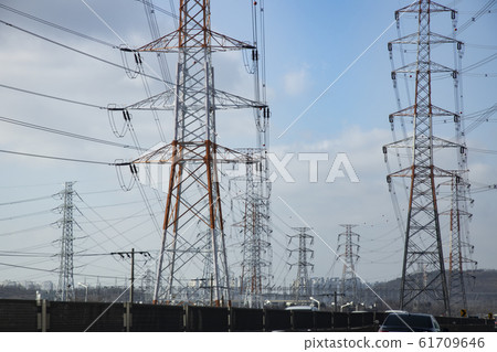 Huge transmission tower around the motorway Huge transmission tower around the motorway 61709646