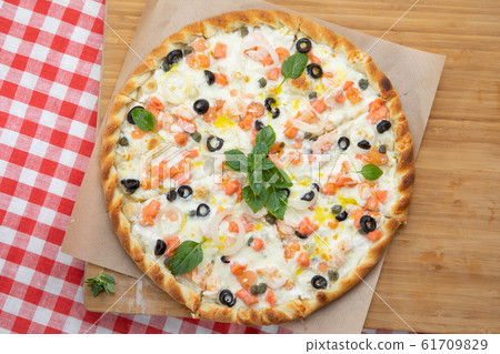 Close-up seafood pizza with various ingredients decorated with Basil Close-up seafood pizza with various ingredients decorated with Basil 61709829