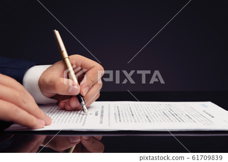 Lawyer, notary, attorney signs document Lawyer, notary, attorney signs document 61709839