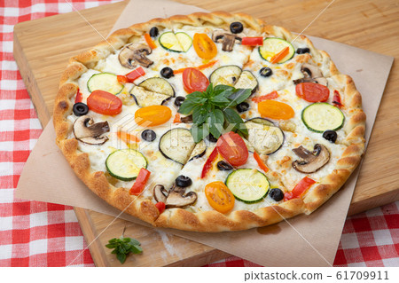 Pizza with vegetables close-up with various ingredients decorated with Basil Pizza with vegetables close-up with various ingredients decorated with Basil 61709911
