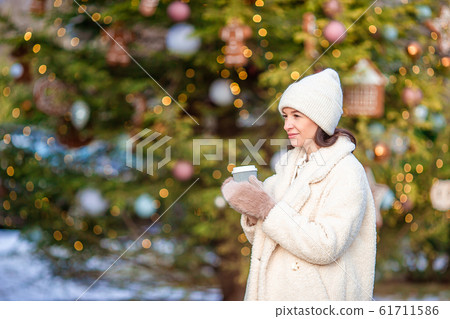 Smiling young girl skating on ice rink outdoors Smiling young girl skating on ice rink outdoors 61711586