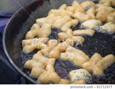 Chinese doughnut (Patongko) Chinese Bread stick or Frying deep fried dough stick in pan Chinese doughnut (Patongko) Chinese Bread stick or Frying deep fried dough stick in pan 61712977