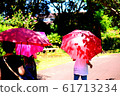Person holding a parasol 61713234