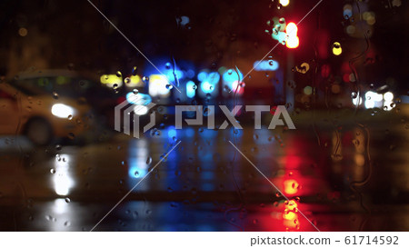 Window glass in rainy day. Bokeh night traffic lights Window glass in rainy day. Bokeh night traffic lights 61714592