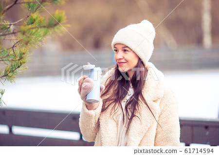 Smiling young girl skating on ice rink outdoors Smiling young girl skating on ice rink outdoors 61714594
