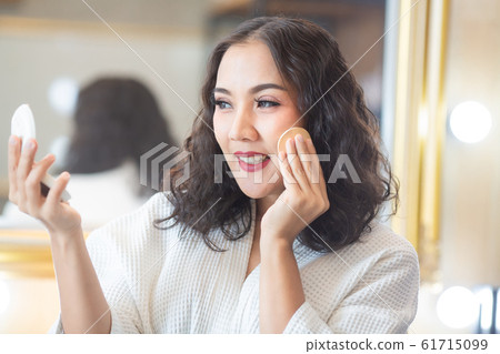 Beautiful girl makeup with her cosmetics Beautiful girl makeup with her cosmetics 61715099
