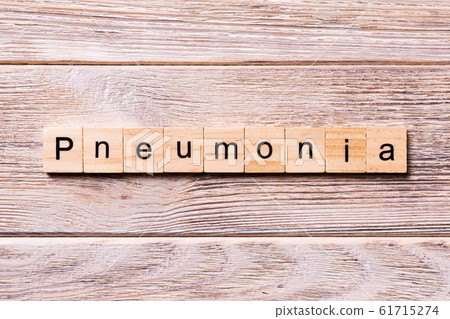 pneumonia word written on wood block. pneumonia pneumonia word written on wood block. pneumonia 61715274