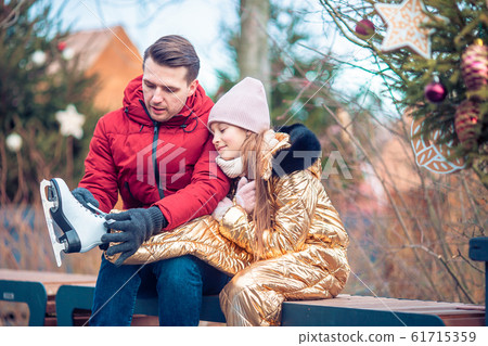 Family winter sport. Father and daughter on winter day 61715359
