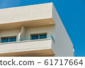 Modern new building with open balconies against the summer blue sky 61717664