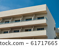 Modern new building with open balconies against the summer blue sky 61717665