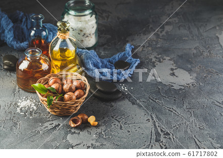 Natural macadamia oil in a glass bottle with Natural macadamia oil in a glass bottle with 61717802