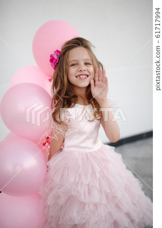 portait of happy young girl with pink balloons portait of happy young girl with pink balloons 61717994