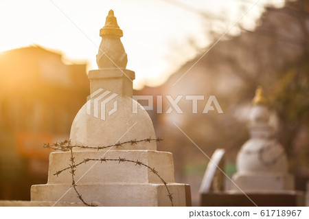 The Buddhist stupas entangled by a barbed wire The Buddhist stupas entangled by a barbed wire 61718967