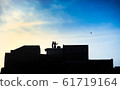 Children on the rooftop play with kites. 61719164