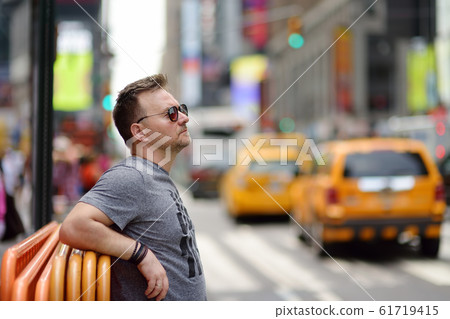 Middle age man tourist looking on Times Square Middle age man tourist looking on Times Square 61719415