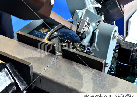 Automatic CNC band saw cutting  tool steel bar by automatic feed. 61720026