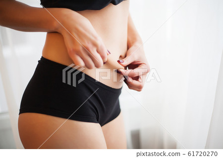 Weight Loss. Closeup Of Hot Sexy Female With Hand Pinching Skin 61720270