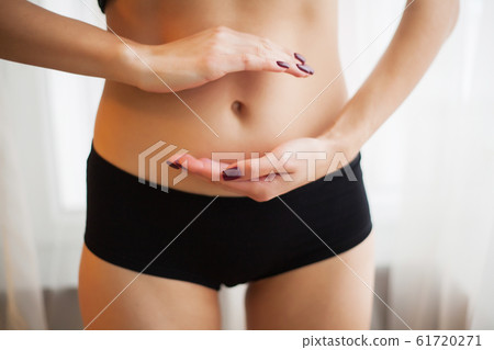 Stomach health concept. Woman holding hands on a belly with the drawing arrows 61720271