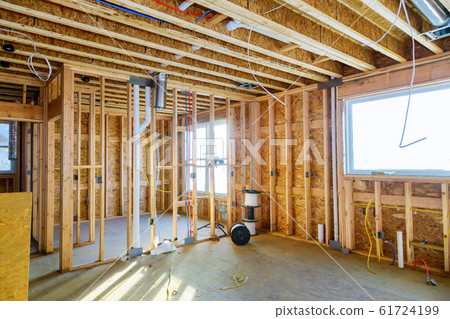 Interior with wood framing beam of new house under 61724199