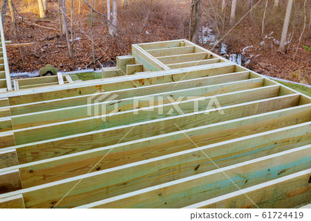 Installing flooring of wooden patio terrace planks Installing flooring of wooden patio terrace planks 61724419